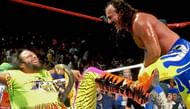 Jake Roberts ties Macho Man up in the ropes as he is bitten by Roberts' cobra
